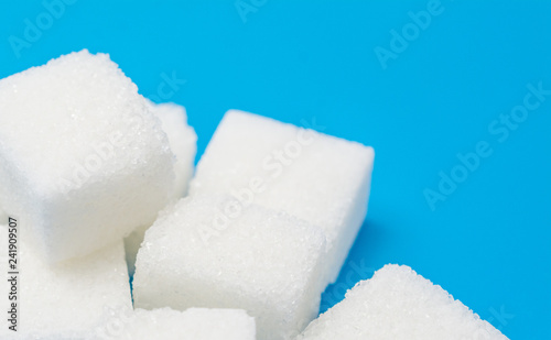 Sugar cubes over blue background with copyspace