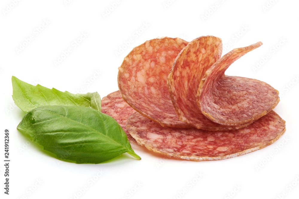 Sliced Salami. Thin Smoked sausage slices with basil leaves, isolated on a white background. Close-up Sliced Salami. Thin Smoked sausage slices with basil leaves, isolated on a white background. Close-up
