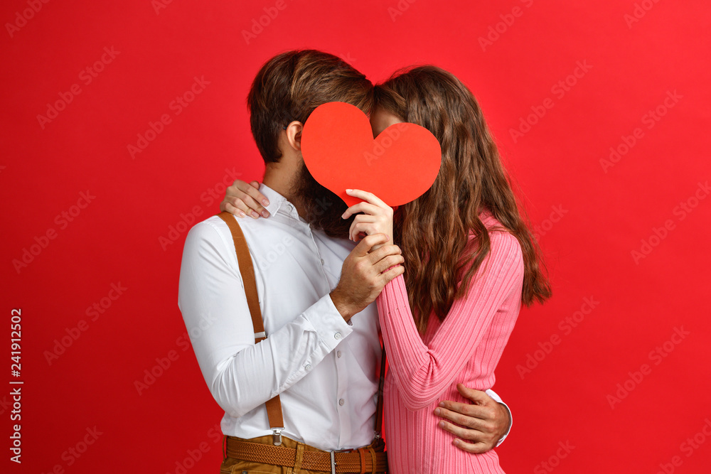 valentine's day concept. happy young couple with heart on red - obrazy, fototapety, plakaty 