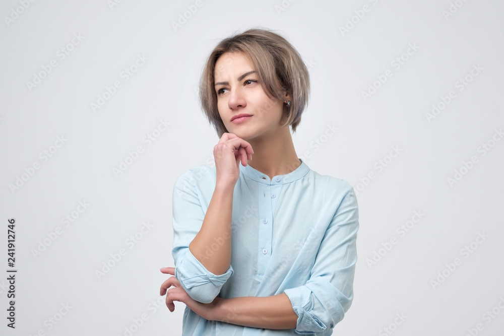 young european woman thinking against white wall young european woman thinking against white wall