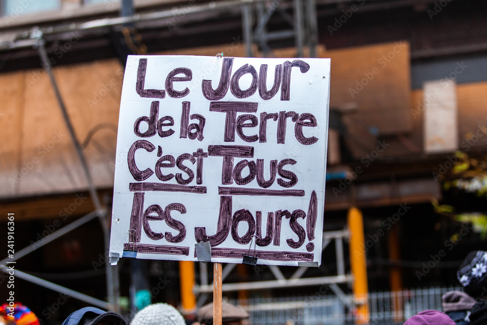 Activists marching for the environment. French sign seen in an ecological protest saying the earth day is everyday
