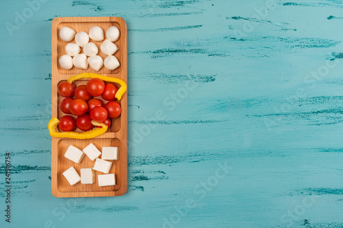 Cheese compartmental dish with different cheeses, on rustic wooden background. photo