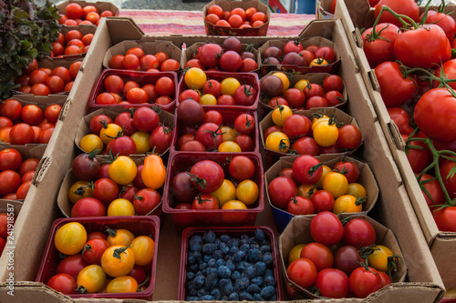 Tomatoes being sold at the market. Close up picture shot outside on a sunny day in a french farmer's market of Quebec, Canada.