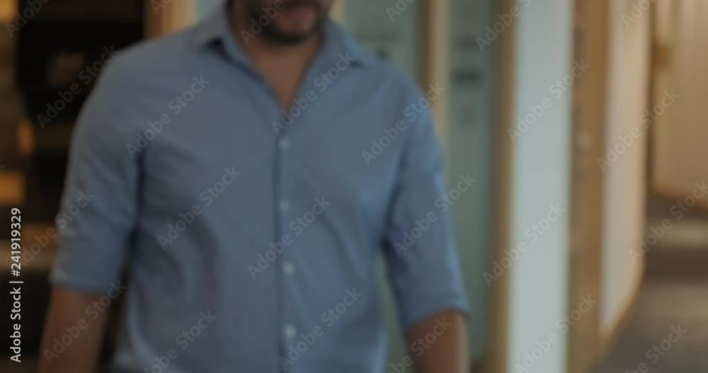 Portrait of confident hispanic businessman looking at camera in office. Young latino business man at work. Happy caucasian manager smiling. Slow motion Portrait of confident hispanic businessman looking at camera in office. Young latino business man at work. Happy caucasian manager smiling. Slow motion