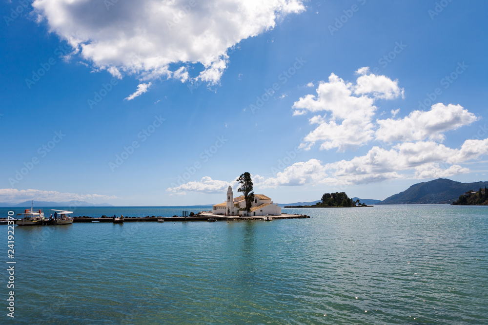 Tranquil scene of the Panagia Vlacherna church and the Mouse Island with a nice cloudscape in Corfu, Greece