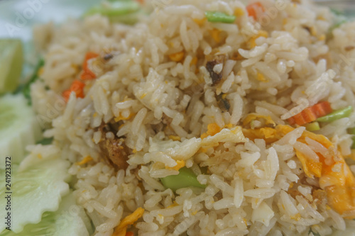 Asian fried rice with eggs, corn and parsley close-up on a plate