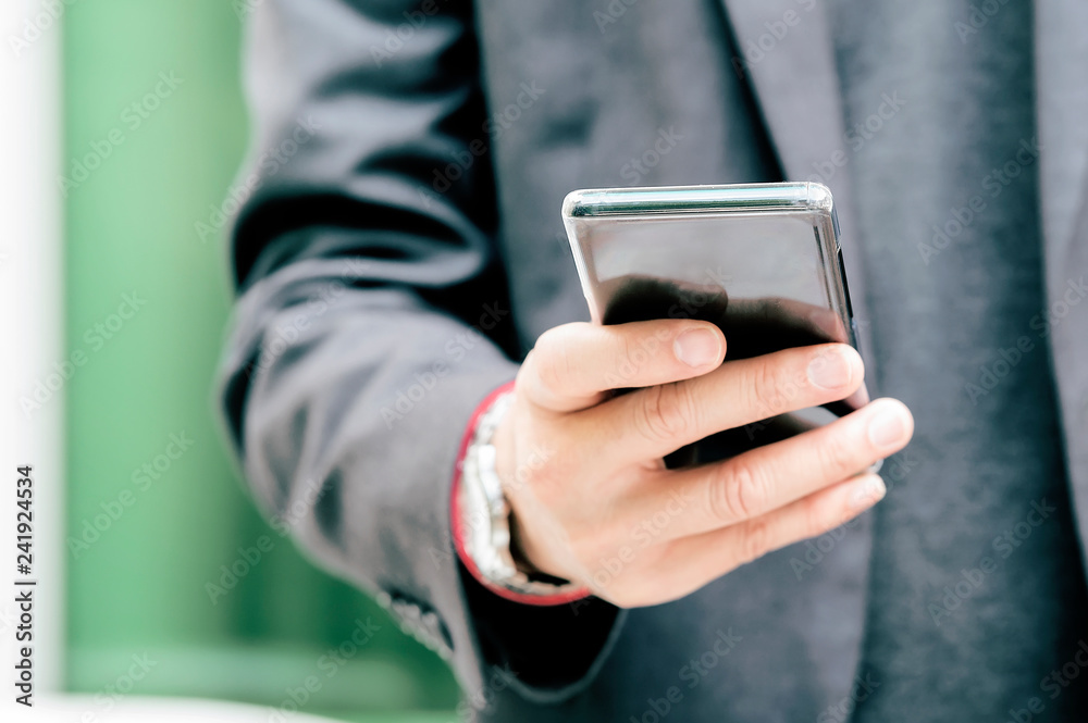 Close up of a business man using mobile smart phone Close up of a business man using mobile smart phone