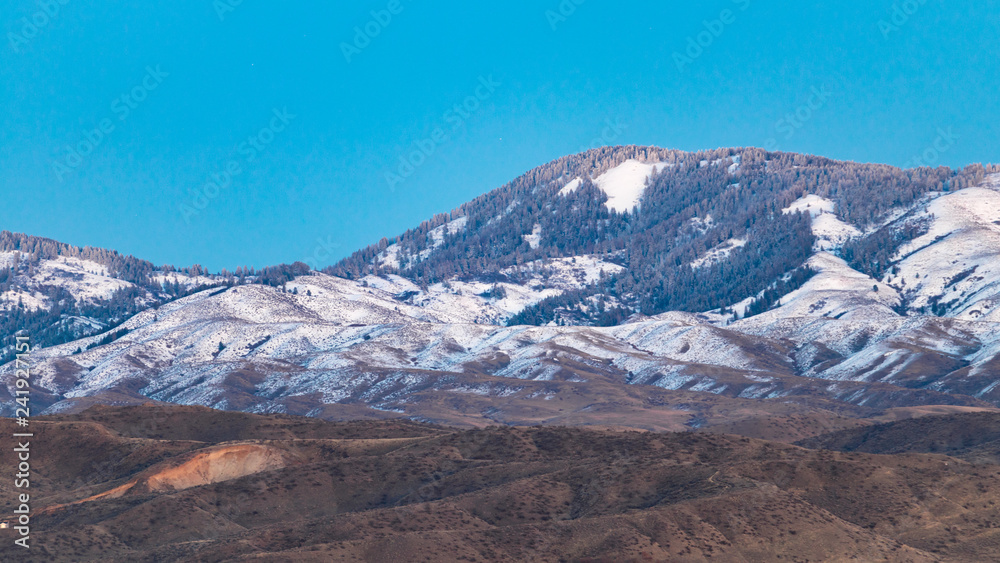 Light snow partially covers the foothills of Boise, Idaho on a clear winter day. Light snow partially covers the foothills of Boise, Idaho on a clear winter day.