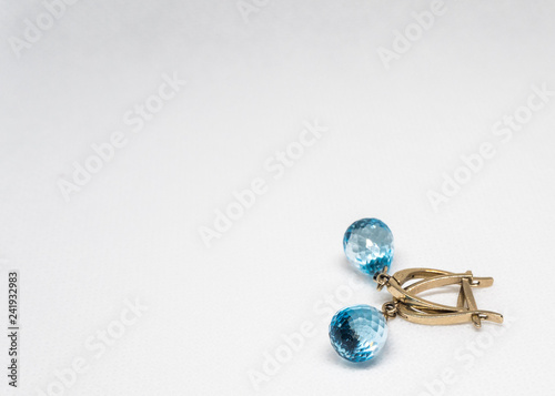 Gold earrings with blue stone