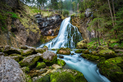 Fototapeta Naklejka Na Ścianę i Meble -  Idyllic waterfall scene with mossy rocks in the forest