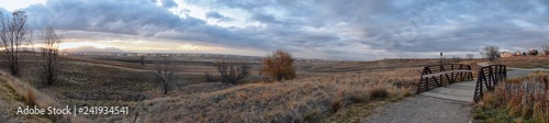 Views of Josh’s Pond walking path, Reflecting Sunset in Broomfield Colorado surrounded by Cattails, plains and Rocky mountain landscape during sunset. United States. © Jeremy