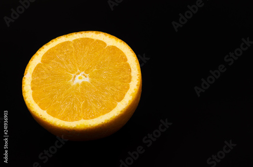 Half an orange isolated on black