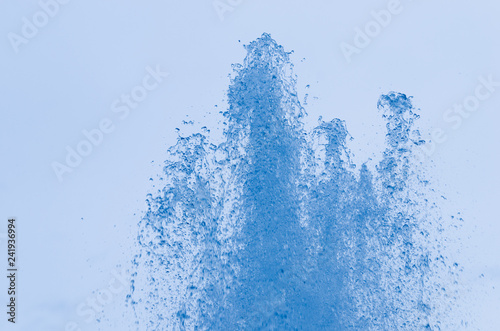 Closeup of ice-blue water drops in air