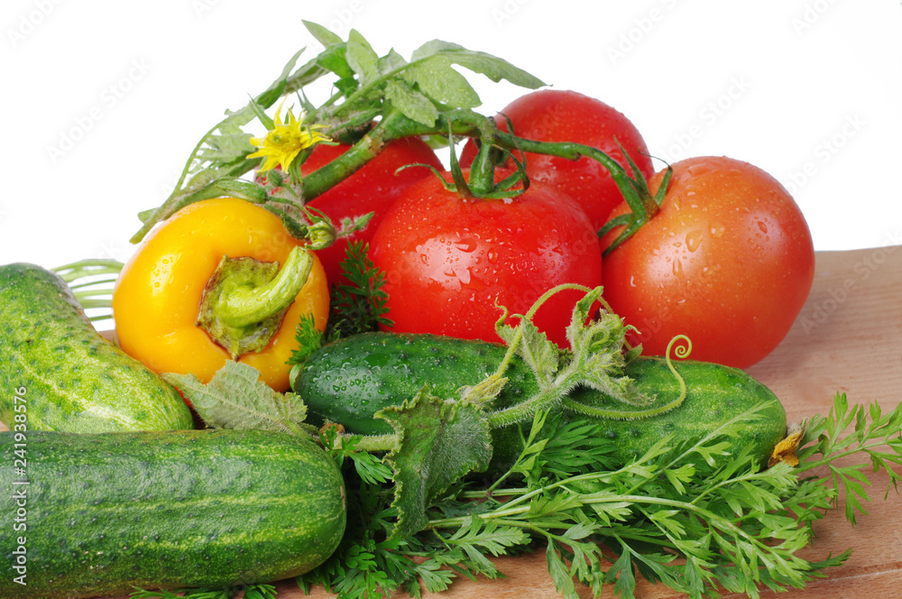 Tomatoes and cucumbers on the kitchen board. Close-up Tomatoes and cucumbers on the kitchen board. Close-up