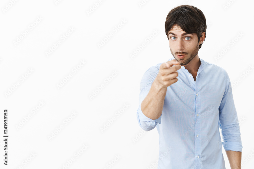 You better watch out. Serious-looking bossy and displeased attractive male entrepreneur in shirt looking, pointing at camera as displeased with unproductive work warning employee he might be fired You better watch out. Serious-looking bossy and displeased attractive male entrepreneur in shirt looking, pointing at camera as displeased with unproductive work warning employee he might be fired
