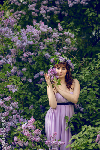 beautiful girl in purple dress with lilac flowers