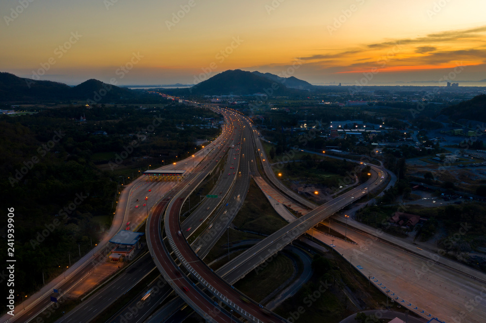 Fototapeta premium Aerial view. Highway intersections and traffic at twilight