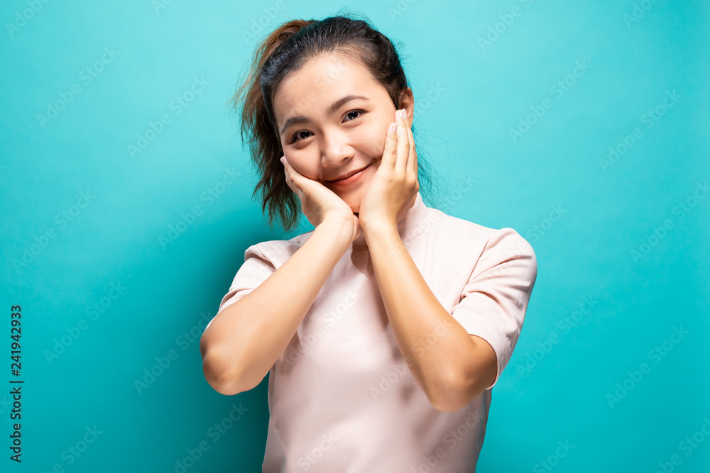 Happy woman standing isolated over blue background Happy woman standing isolated over blue background