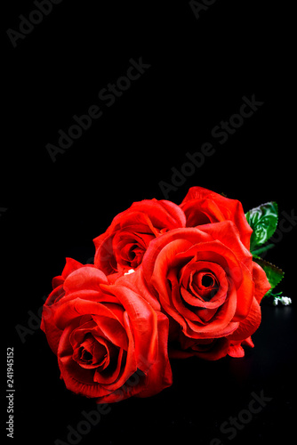 Fototapeta Naklejka Na Ścianę i Meble -  Bouquet of red roses on black background