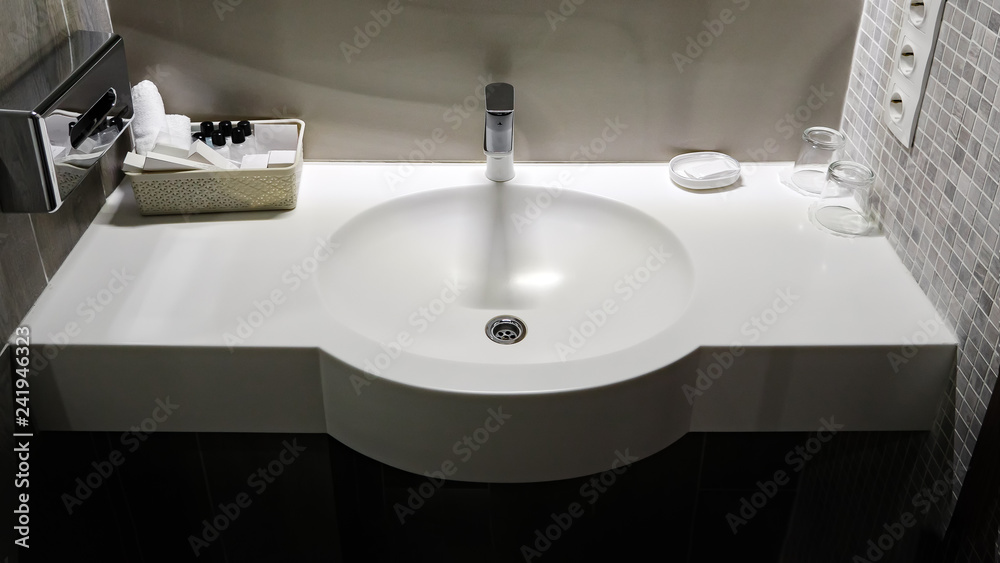 Bath room sink with white cleaning set in a hotel Bath room sink with white cleaning set in a hotel