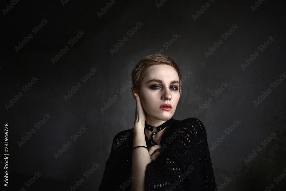 Fototapeta premium Girl with short hair holds hands around face