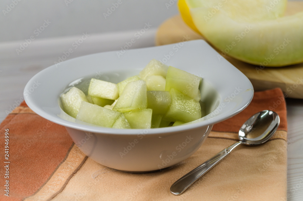 Eat fresh and healthy concept. Delicious honeydew cut in a bowl on a table. Eat fresh and healthy concept. Delicious honeydew cut in a bowl on a table.