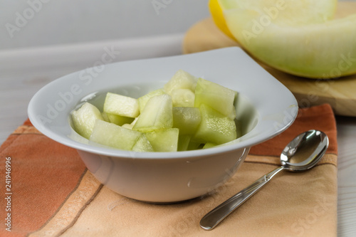 Eat fresh and healthy concept. Delicious honeydew cut in a bowl on a table.