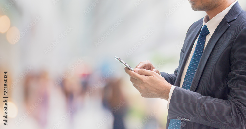 Businessman using smart phone in office space interior background and copy space.Concept of people shopping online technology. Businessman using smart phone in office space interior background and copy space.Concept of people shopping online technology.