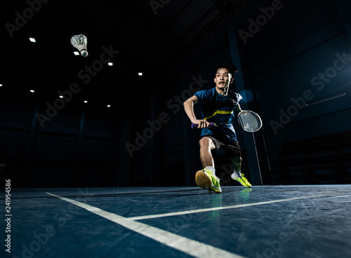 Fototapeta Naklejka Na Ścianę i Meble -  Asian badminton player is hitting in court