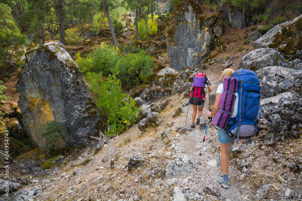 A couple of backpackers goes by the rocky Lycian way