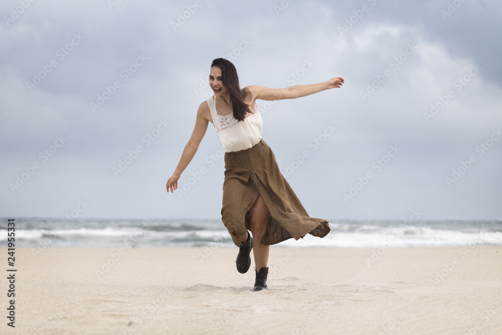 Lifestyle portrait of happy carefree woman walking on the beach Lifestyle portrait of happy carefree woman walking on the beach