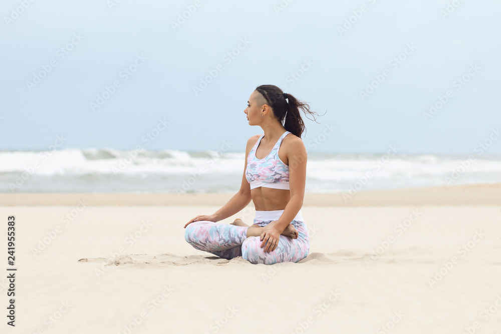 Young woman doing yoga exercise on the beach Young woman doing yoga exercise on the beach