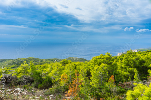 Greece, Zakynthos, Endless blue ocean behind green mountains © Simon