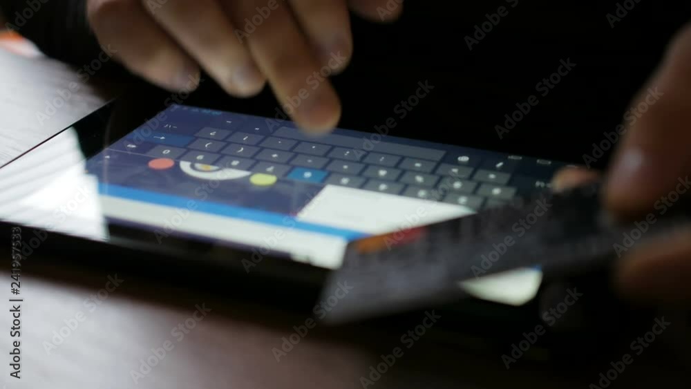 Shopping online with credit card on digital tablet pc. Closeup. Online banking with smartphone. Shopping online with credit card on digital tablet pc. Closeup. Online banking with smartphone.