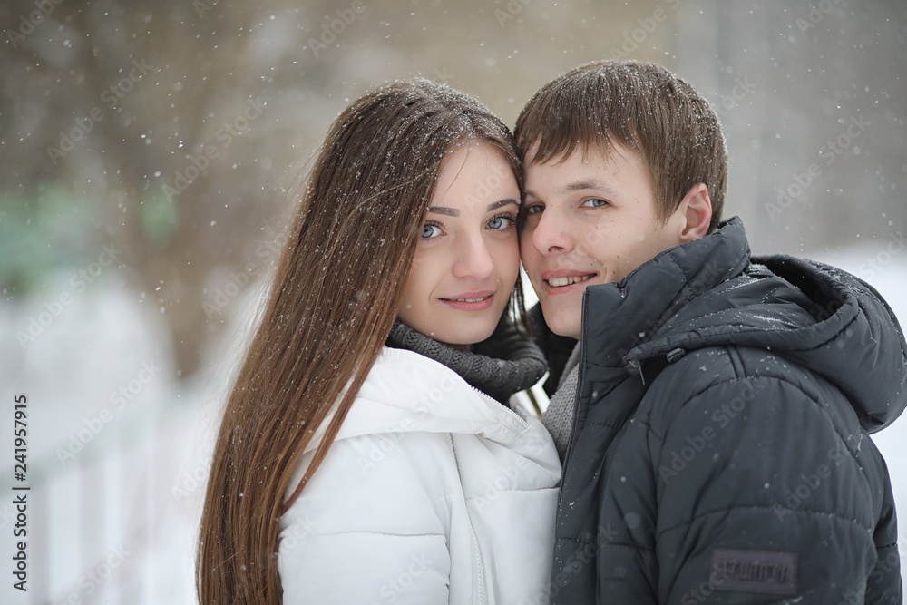 pair of lovers on a date winter afternoon in a snow blizzard pair of lovers on a date winter afternoon in a snow blizzard