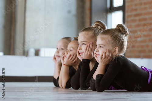 The choreographer teaches children to dance. Kids dance class in loft studio with windows and sunlight