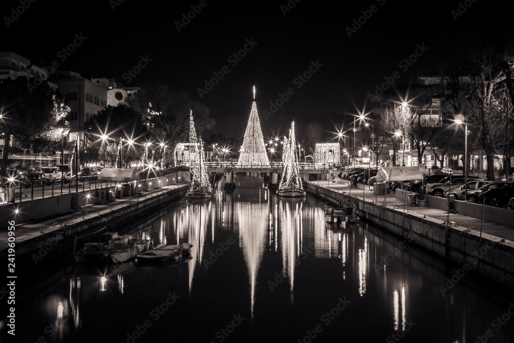 View of the Christmas Tree on a bridge at night in black and white. Long exposure picture in Riccione, Emilia Romagna, Italy.