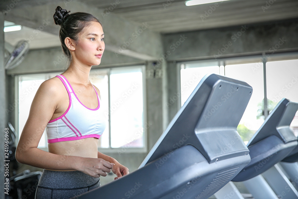 Women are entering a weight control program. Young people running on Treadmill. Young woman training in the gym. Beautiful athletic woman training in the fitness. Women are entering a weight control program. Young people running on Treadmill. Young woman training in the gym. Beautiful athletic woman training in the fitness.
