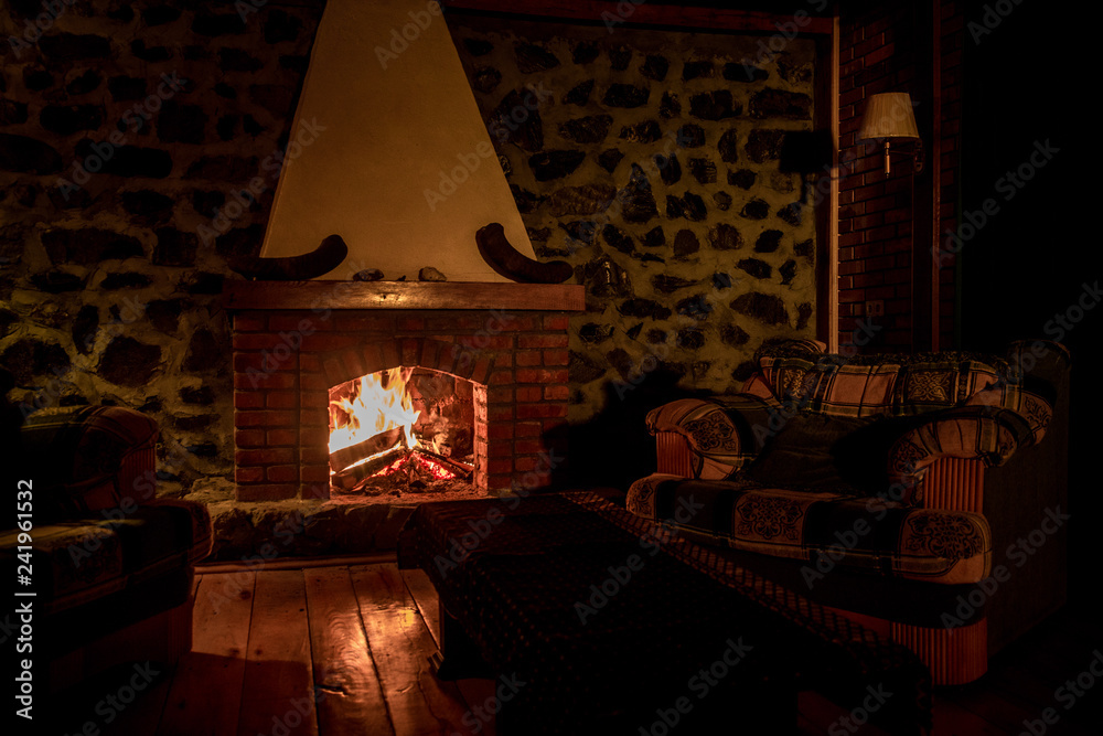 Autumn or winter burning fireplace cozy evening concept close up. Close up shot of burning firewood in the fireplace. - obrazy, fototapety, plakaty 