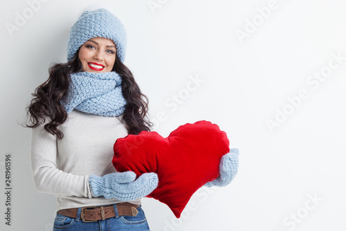 Woman with red heart shape pillow