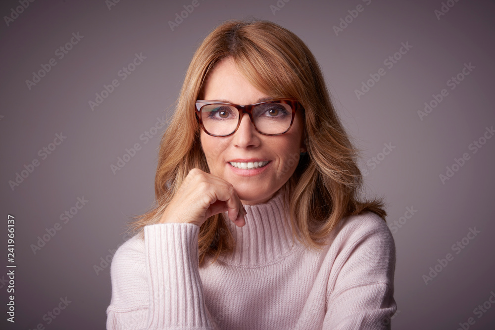 Confident mature woman studio portrait