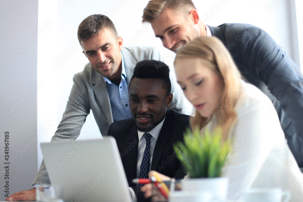 Business people in discussing something while sitting together at the table. Business people in discussing something while sitting together at the table.