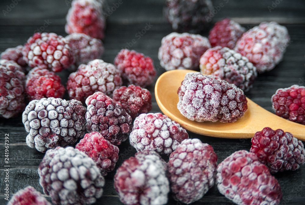 Frozen blackberries on a wooden table. Frozen blackberries on a wooden table.