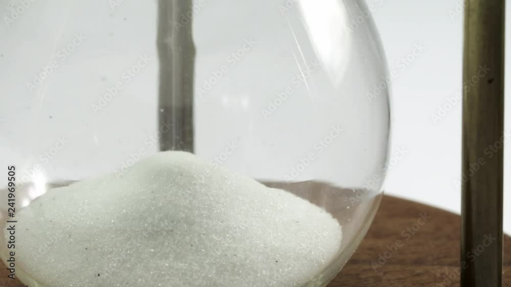 White sand flowing in the hourglass