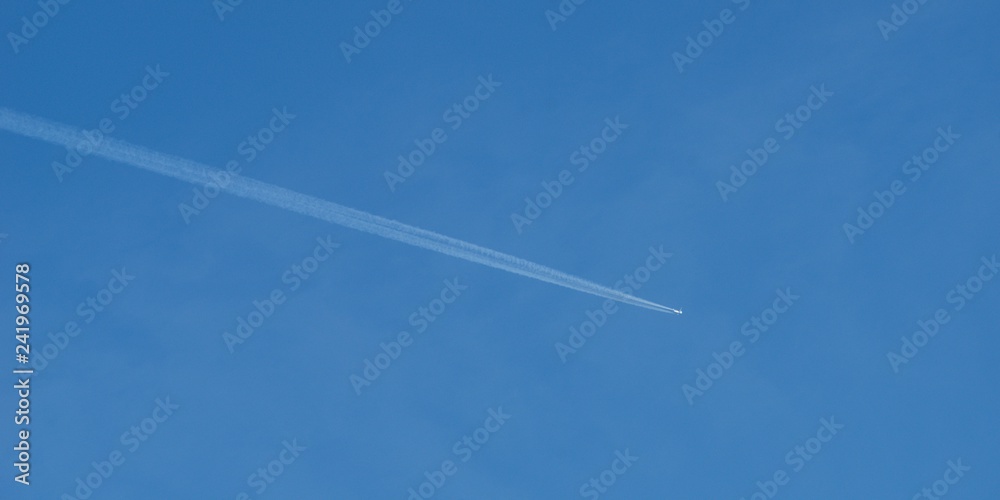 Plane flying on a blue sky, condensation line. Plane flying on a blue sky, condensation line.
