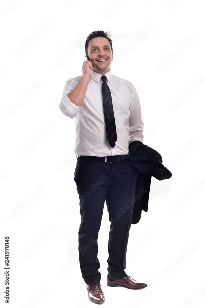 Young businessman wearing a black suit with white shirt and black tie, holding his jacket and his phone, posing, isolated on white Young businessman wearing a black suit with white shirt and black tie, holding his jacket and his phone, posing, isolated on white
