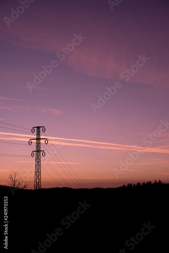 Power line mast, electrical network distribution background in the sky.