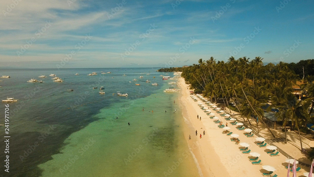 Aerial view tropica Alona beach on the island Bohol, resort, hotels, Philippines. Beautiful tropical island with sand beach, palm trees. Tropical landscape. Seascape: Ocean, sky, sea. Travel concept Aerial view tropica Alona beach on the island Bohol, resort, hotels, Philippines. Beautiful tropical island with sand beach, palm trees. Tropical landscape. Seascape: Ocean, sky, sea. Travel concept