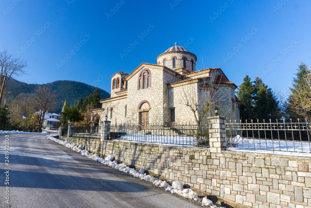 Church of Saint Kiriaki covered with snow in Megalo Chorio, a winter destination in Evritania near Karpenissi in Greece