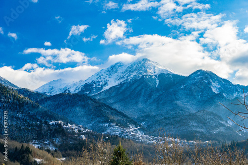 Panoramic view of Megalo chorio village and the snow covered Kaliakouda mountain in Karpenissi, Evritania, Greece